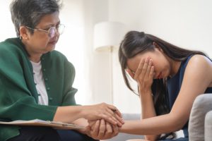 Sad young woman crying over wrongful death of a loved one